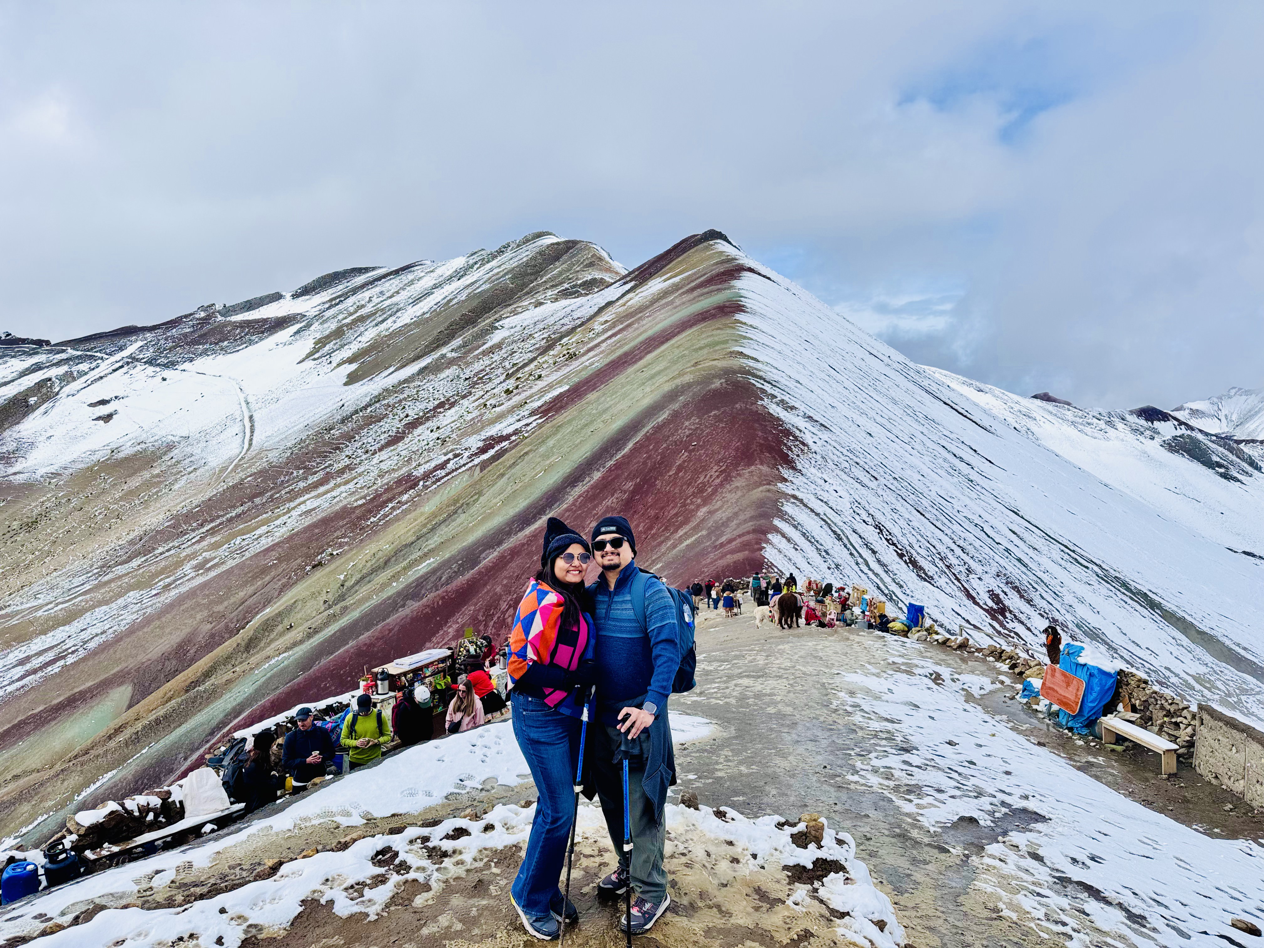 Abhishek and Shreya on the ridge at Rainbow Mountain, Peru, in fresh snow